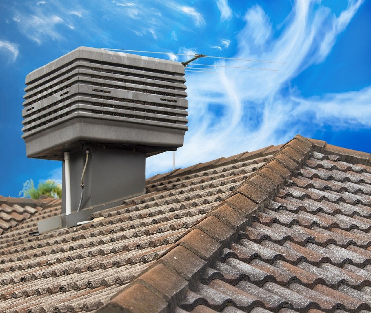 Evaporative cooling unit on the roof of a house | Air Conditioning Doctor