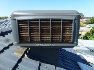 evaporative air conditioner on the roof of a house